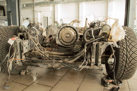 The chassis of the car without the engine and the body is on the lift in the service station.