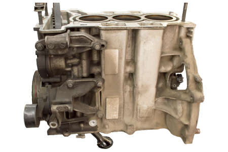 The block crankcase of the three-cylinder internal combustion engine removed from the car hangs on...