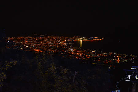 Top view of the lights of the night city located on the shore of the sea Bayの写真素材