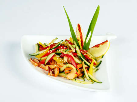 fresh vegetarian salad mix isolated on a white plateの写真素材