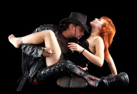 man making tattoo to a girl isolated over blackの写真素材