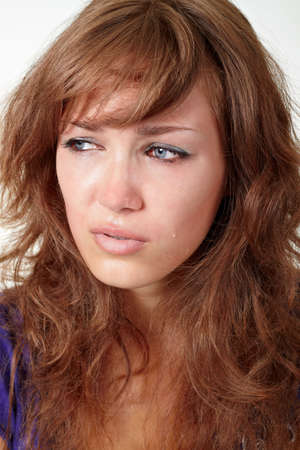 Beautiful girl crying isolated over whiteの写真素材