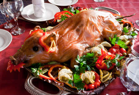 whole roasted piglet served on a trayの写真素材