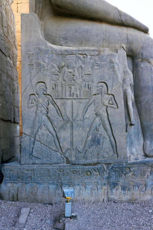 Hieroglyphics on throne of of Ramses II Statue at the entrance of Luxor temple, Egyptの写真素材