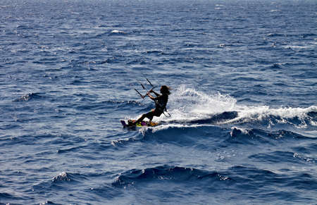 Unidentified man kitesurfing in Red Sea waters in Egypt, Safaga, on October 2011