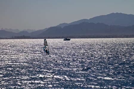 Unidentified man windsurfing in Red Sea waters in Egypt, Safaga, on October 2011