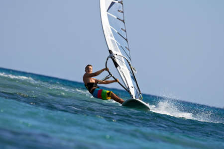 Fast approaching windsurfer mooving almost horizontallyの写真素材
