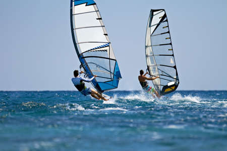Windsurfers in action on bright sunny dayの写真素材