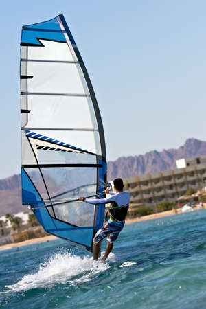 Rear view of a windsurfer passing byの写真素材