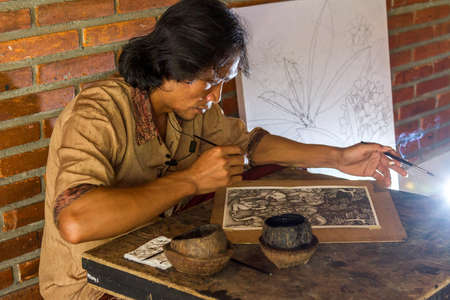 Young painter drawing in gallery, Bali, Indonesiaの写真素材