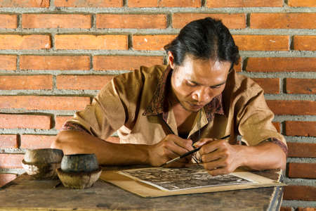 Young painter drawing in gallery, Bali, Indonesiaの写真素材