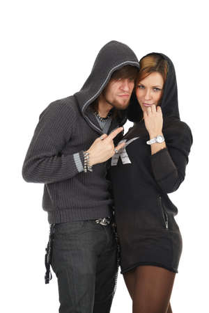 Cool modern young couple in hoods looking with conspiracyの写真素材