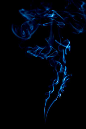 blue rings and curls of smoke on black backgroundの写真素材
