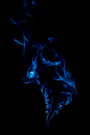 blue rings and curls of smoke on black backgroundの写真素材