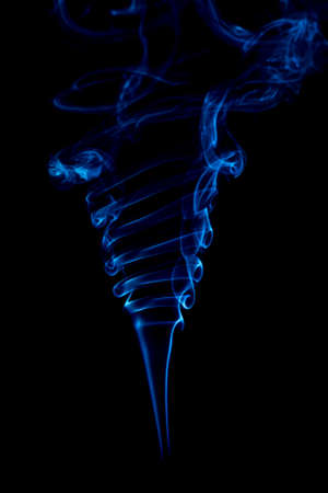 blue rings and curls of smoke on black backgroundの写真素材