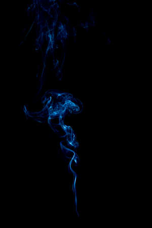 blue rings and curls of smoke on black backgroundの写真素材