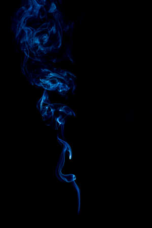 blue rings and curls of smoke on black backgroundの写真素材