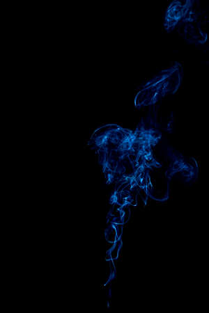 blue rings and curls of smoke on black backgroundの写真素材