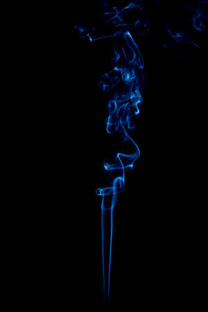 blue rings and curls of smoke on black backgroundの写真素材