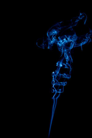 blue rings and curls of smoke on black backgroundの写真素材