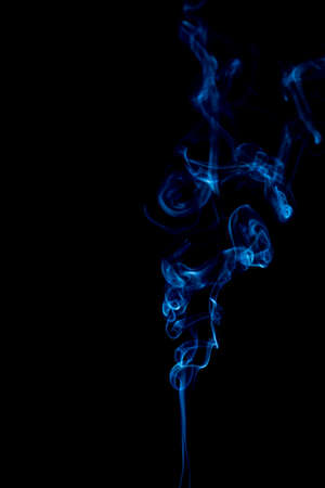 blue rings and curls of smoke on black backgroundの写真素材