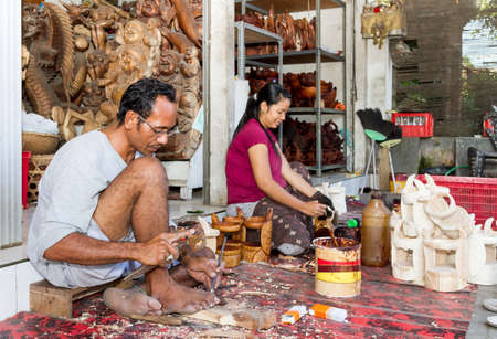 A man and a woman are making wooden crafts  in Indonesiaのeditorial素材