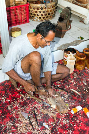 A man is making wooden crafts  in Indonesiaのeditorial素材