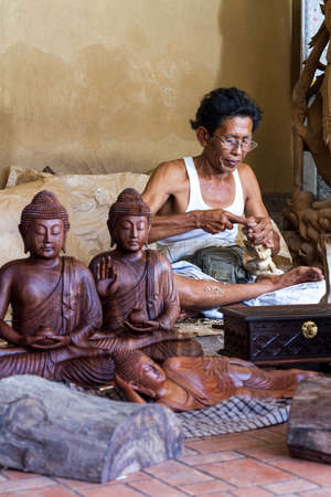 A man is making wooden crafts  in Indonesiaの写真素材