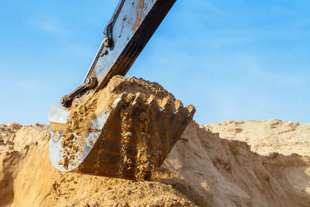 Excavator Bucket across the Blue Skyの写真素材