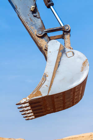 Excavator Bucket across the Blue Skyの写真素材