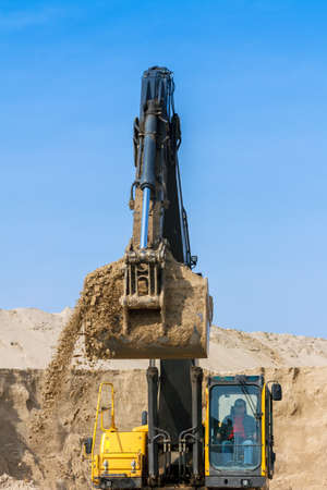 Yellow Excavator work at Construction Siteの写真素材