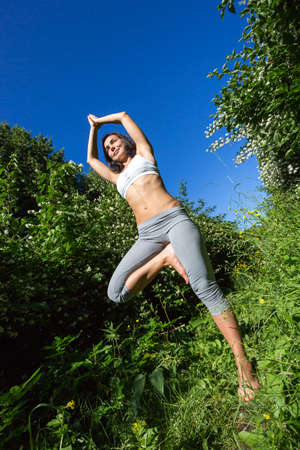 girl doing yoga outdoor and smilingの写真素材