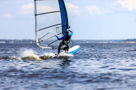 Rear view of a windsurfer passing byの写真素材