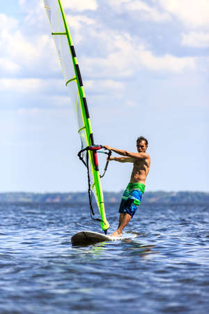 Front view of a windsurfer passing byの写真素材