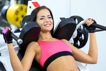young women do a workout at the gym and smilingの写真素材