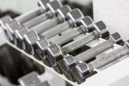 Stand with dumbbells. Sports and fitness roomの写真素材