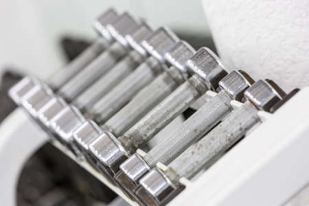 Stand with dumbbells. Sports and fitness roomの写真素材