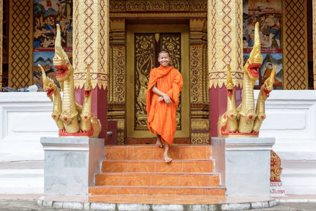 Young Buddhist Monk Walking And Smiling To The Cameraの写真素材