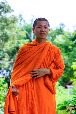 Close-Up Portrait of Young Buddhist Monk at Sunny Dayの写真素材