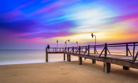 Long exposure of magic unreal colorful sunrise and wooden pier, Nha Trang City Beach, Vietnamの写真素材