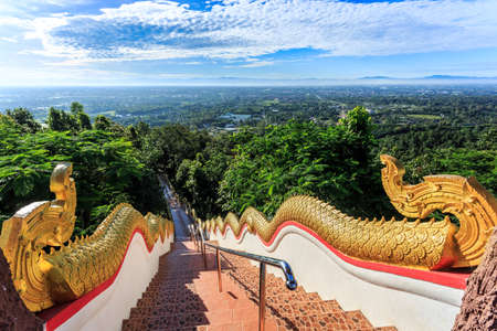 Golden Naka statue on staircase balustrade at Wat Phra That Doi Kham. Temple in Chiang Mai Thailandの写真素材