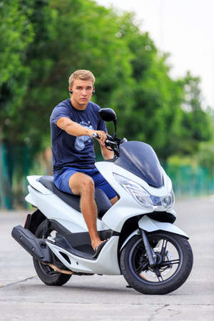 Man posing on a motorcycle at the road