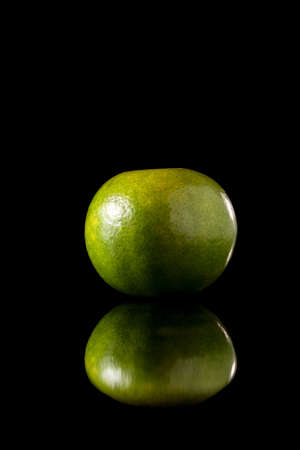 Tangerine green orange fruit on a black reflective background, Studio shot,の写真素材