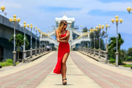 Beautiful Model In Red Dress Walking on The Sarasin Bridge, Phuket, Thailandの写真素材