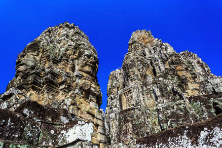 Giant stone faces of ancient buddhist khmer Bayon temple in Angkor Thom, Siem Reap, Cambodiaのeditorial素材