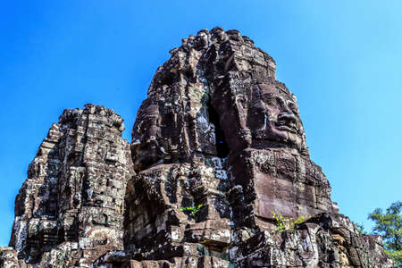 Giant stone faces of ancient buddhist khmer Bayon temple in Angkor Thom, Siem Reap, Cambodiaのeditorial素材