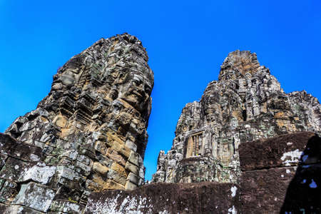 Giant stone faces of ancient buddhist khmer Bayon temple in Angkor Thom, Siem Reap, Cambodiaのeditorial素材