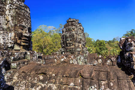 Giant stone faces of ancient buddhist khmer Bayon temple in Angkor Thom, Siem Reap, Cambodiaのeditorial素材