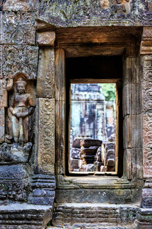 Ancient stone door in ruins of  buddhist khmer temple near Siem Reap, Cambodiaの写真素材