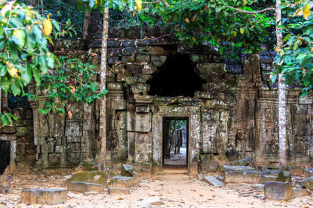 Ancient stone door in ruins of  buddhist khmer temple near Siem Reap, Cambodiaの写真素材